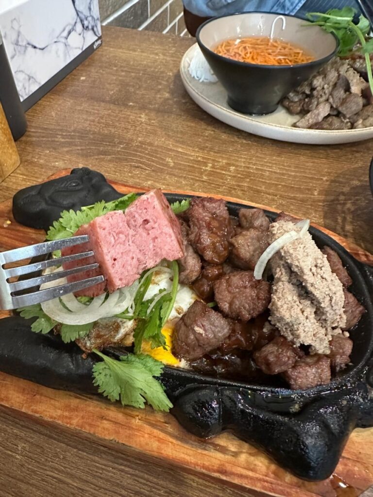Close-up of Vietnamese ham on Bò Né plate showing dry texture