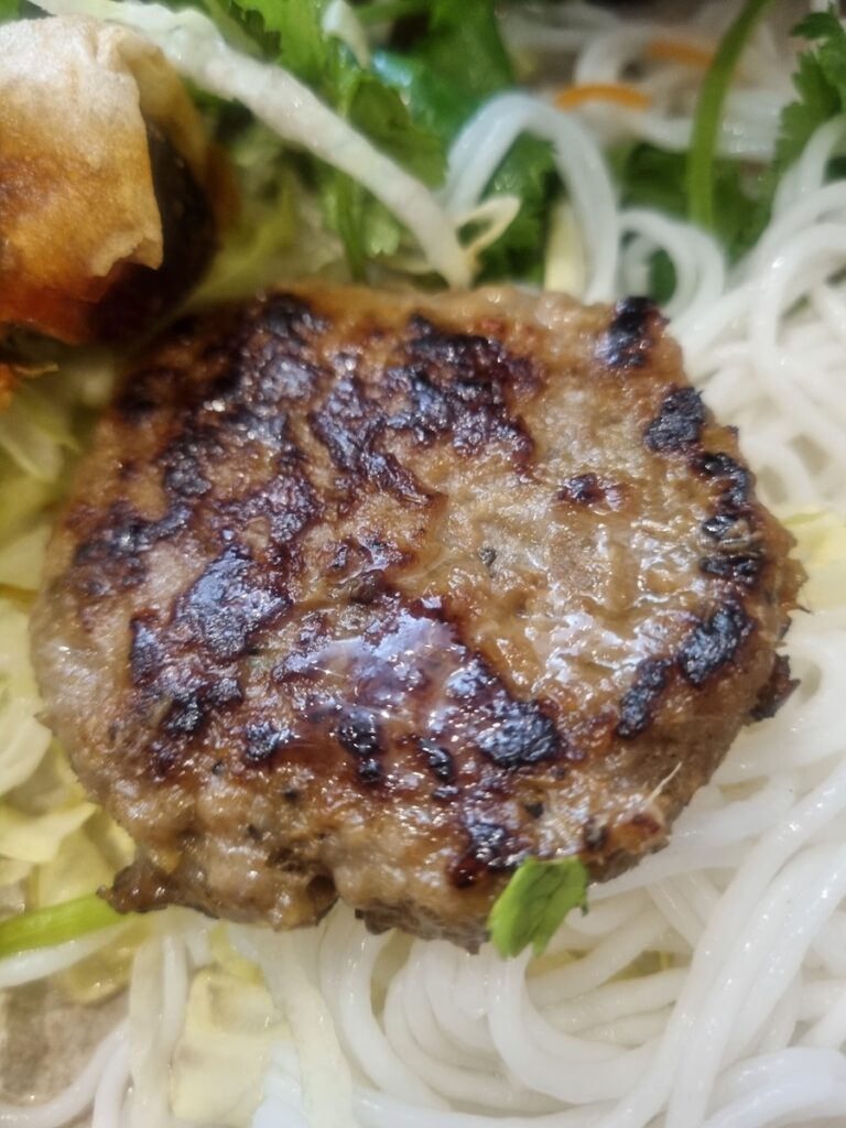 Close-up of juicy pork patty from Bun Cha at Cisne