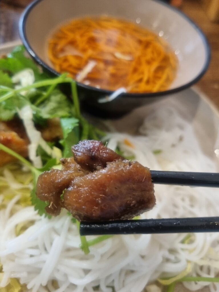 Close-up of lemongrass seasoned BBQ pork from Bun Cha at Cisne
