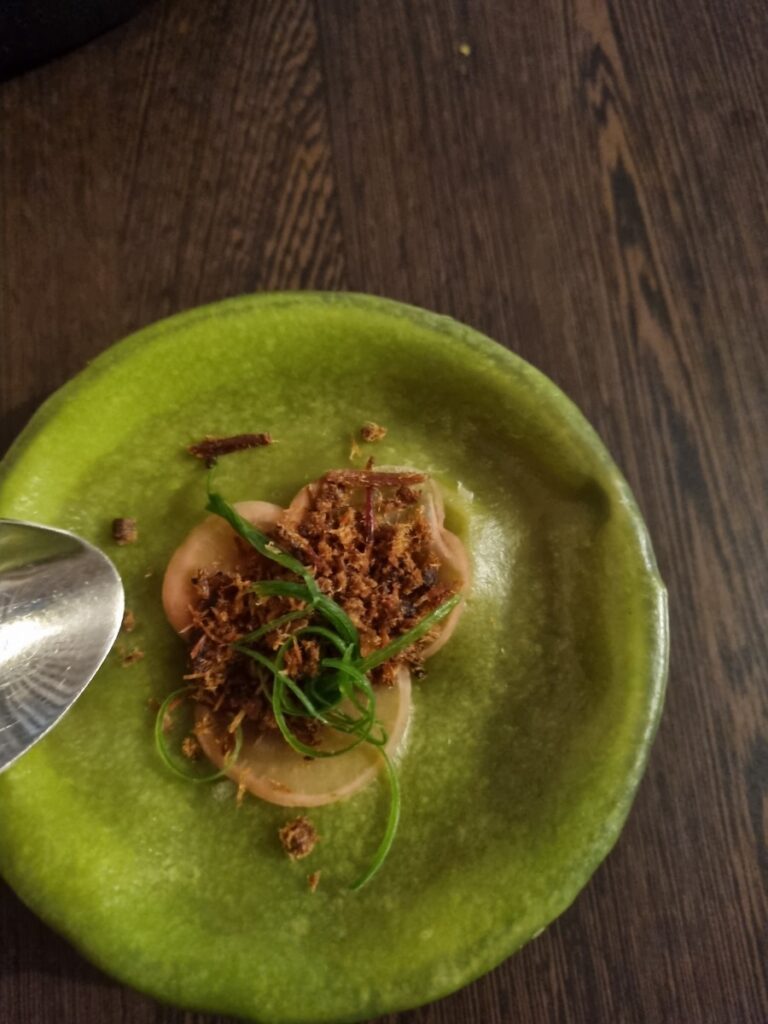 Close-up of Covered Soup at Naadam Restaurant Canberra with spinach dough on top