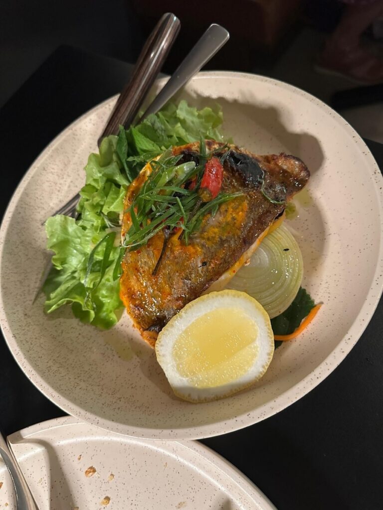 Lemongrass Chilli Baked Snapper with crispy skin and a fresh lemon wedge
