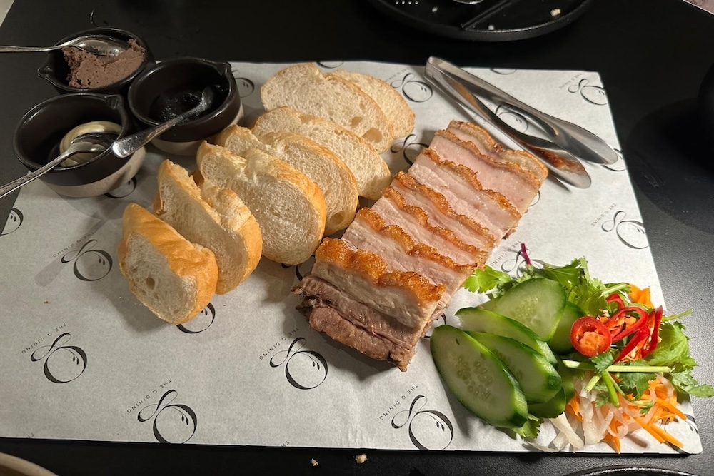 Five Spice Crispy Pork Belly Platter with bread, salad, and dipping sauces in the Q Dining Canberra
