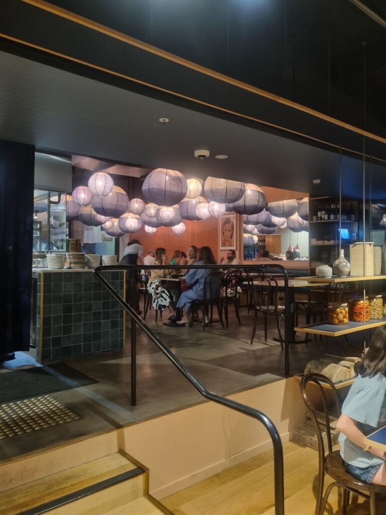 Customers enjoying Japanese and Korean fusion dishes inside Azuma Den Canberra