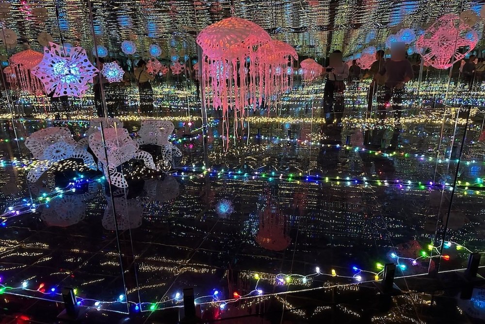 Another view inside the Mirror Room, where lights and mirrors create a dreamy visual effect.
